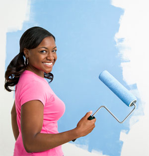 Woman Painting Wall in Garage